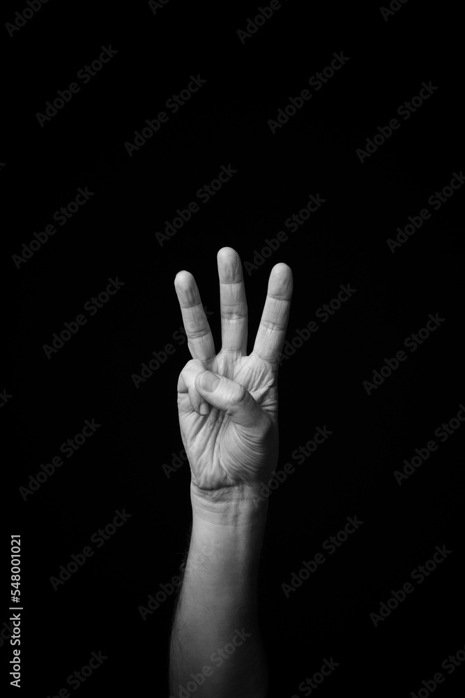 Hand demonstrating the French sign language letter 'W' with copy space Hand demonstrating the French sign language letter 'W' with copy space