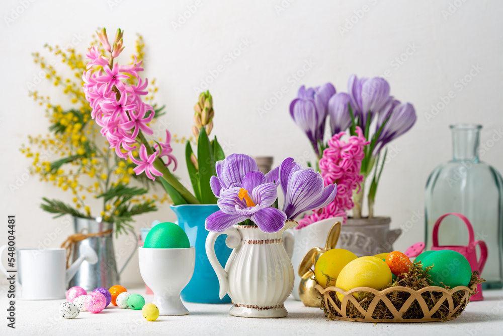 Spring flowers in pot and pitcher Easter background