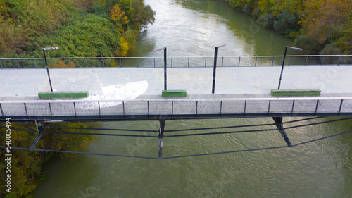 Aerial view over the Tiber River and the Ponte della Scienza, a pedestrian bridge that connects the Lungotevere in Rome, Italy, between the Portuense and Ostiense districts. photo
