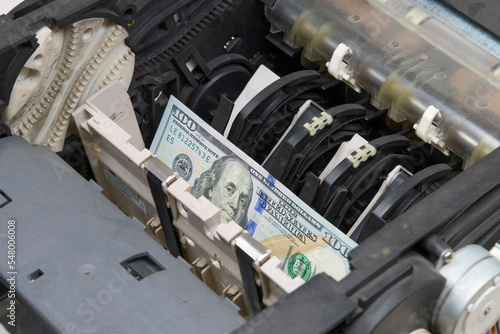 Close-up of maintenance and repair of the drive mechanism of the bill acceptor of an ATM with a jammed bill