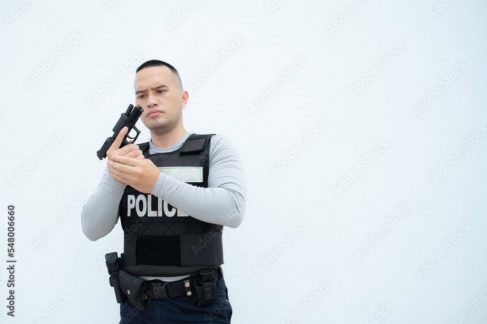 Portrait of police hold gun in hand on white background,Handsome asian cop