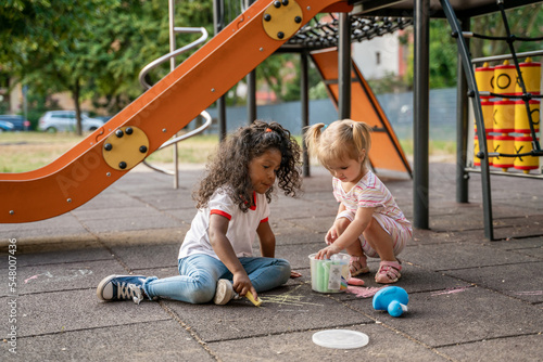 Two kids involved in a creative outdoor activity photo