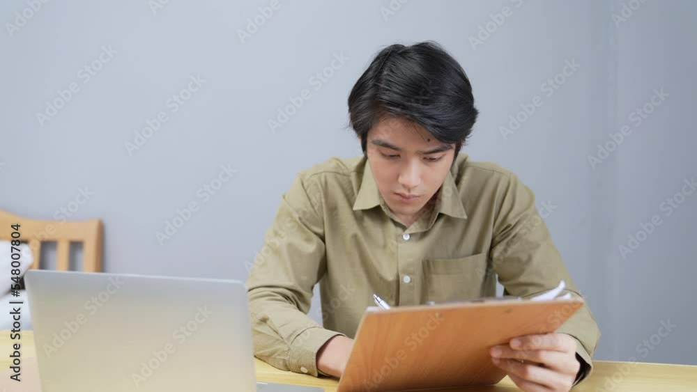 Holiday concept of 4k Resolution. Asian men working at home. computer data entry. students are studying for their own knowledge. Holiday concept of 4k Resolution. Asian men working at home. computer data entry. students are studying for their own knowledge.