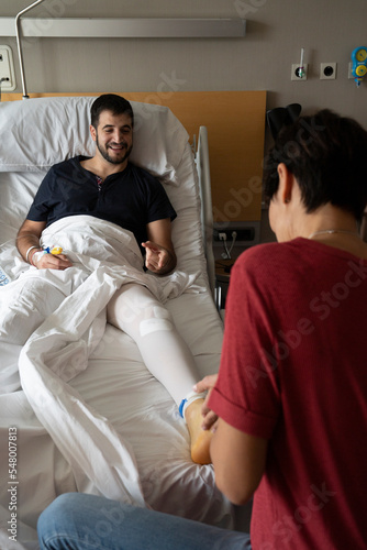 Physiotherapist visiting a patient in the hospital after an operation