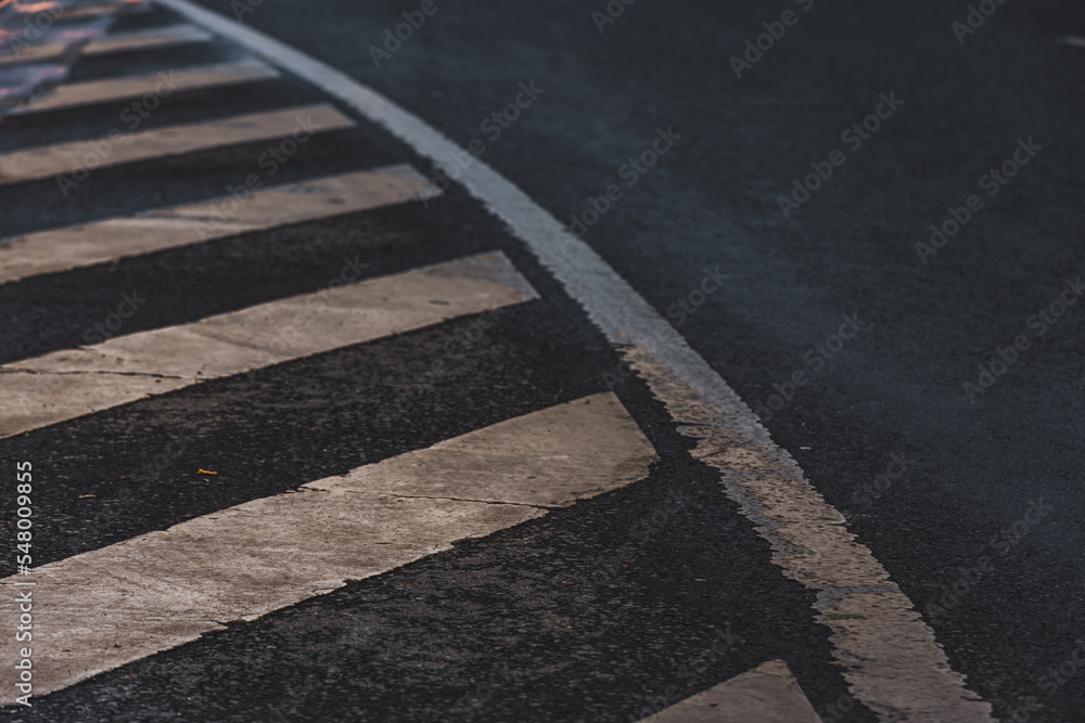 Obraz premium White dirty pedestrian crosswalk painted on black asphalt or road mark for refuge