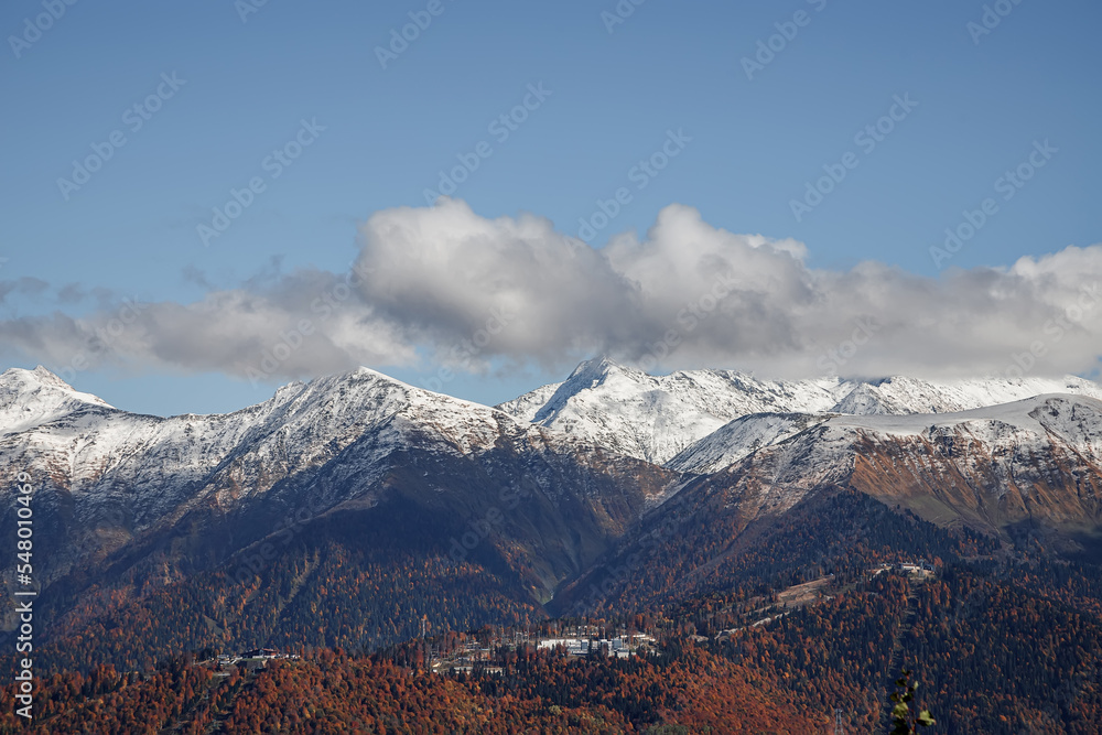 Mountains with snow-capped peaks. Beautiful panorama. Clouds over the mountains. Mountains with snow-capped peaks. Beautiful panorama. Clouds over the mountains.