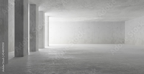 Abstract large, empty, modern concrete room, light thru pillars on the left wall and rough floor - industrial interior background template