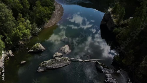 Aerial view of the cascading Uchar waterfall, flowing over rocks and forests photo