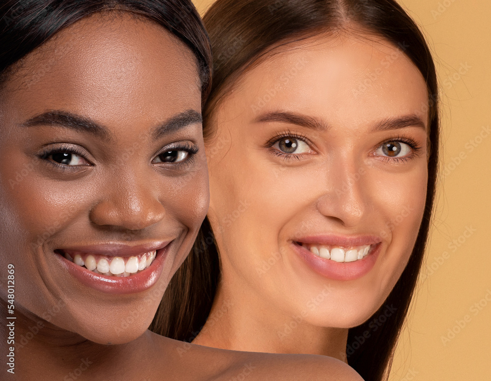 Closeup of attractive multiracial young women smiling at camera Closeup of attractive multiracial young women smiling at camera