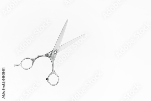 Professional Haircutting Scissors levitation. Hairdresser scissors on white background with copy space for text.