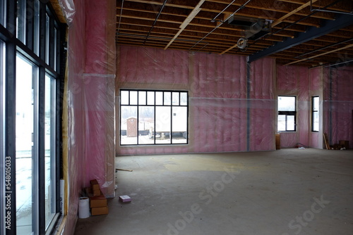 new commercial construction with pink insulation and vapor barrier