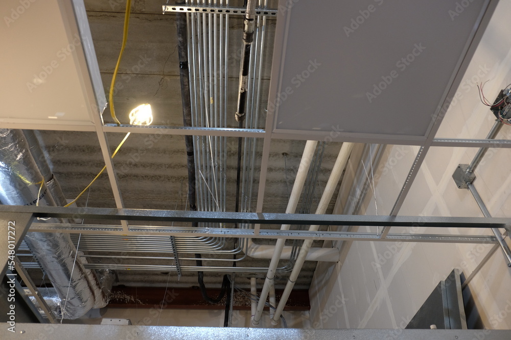 Obraz premium 90 degree bend in conduit above ceiling grid