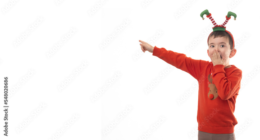 Very adorable young boy with Santa Claus pajama have a lot of fun in photo studio on isolated white background.