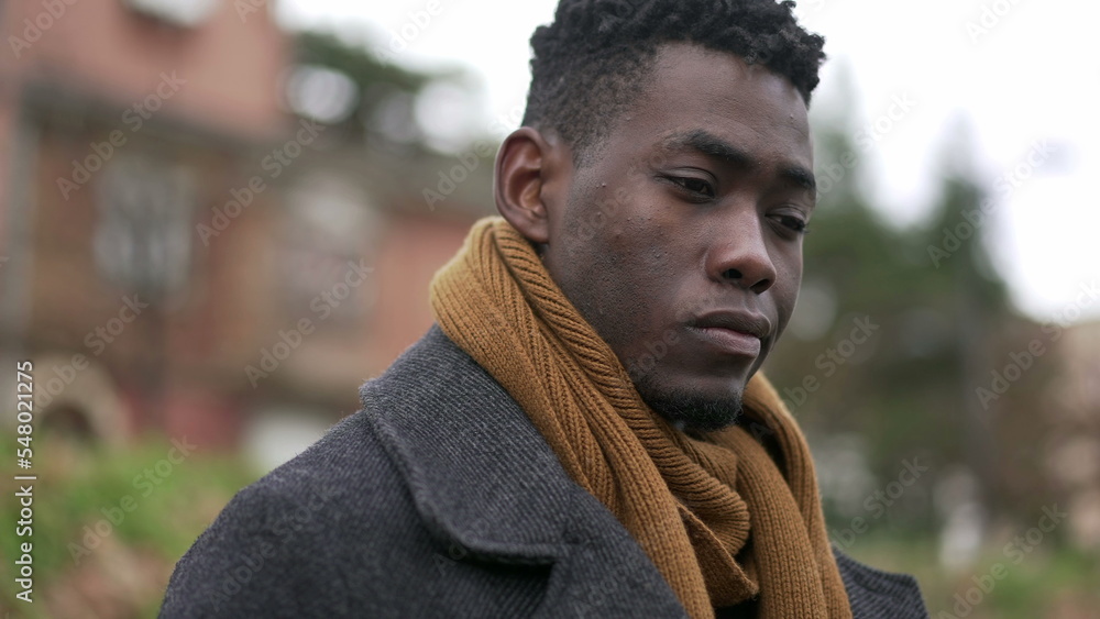 Pensive black African man close-up face thinking about issues Pensive black African man close-up face thinking about issues