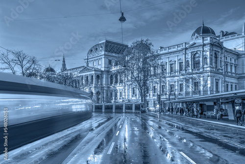 View of the University of Vienna (Universitat Wien) with long exposure of a tram - Vienna,  Austria photo