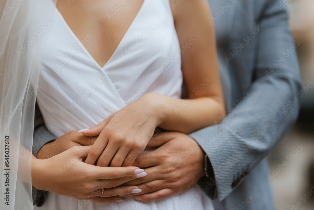 the bride and groom tenderly hold hands between them love and relationships the bride and groom tenderly hold hands between them love and relationships