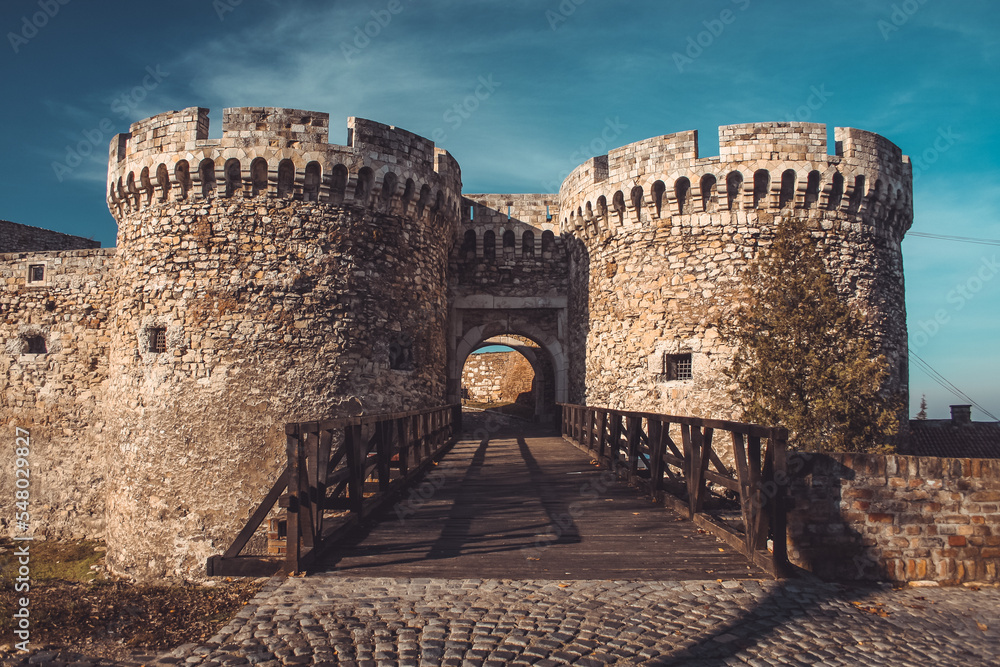 Entrance to famous Kalemegdan fortress over belgrade in autumn sun. Majestic fortress with wooden bridge towards entrance.