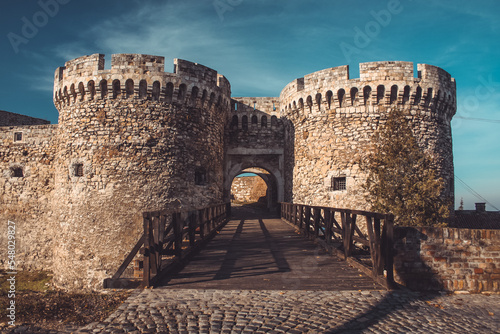 Entrance to famous Kalemegdan fortress over belgrade in autumn sun. Majestic fortress with wooden bridge towards entrance.