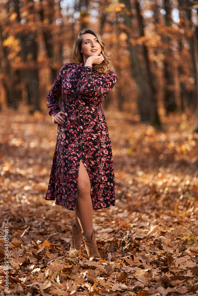 Size plus woman in a forest in the autumn Size plus woman in a forest in the autumn
