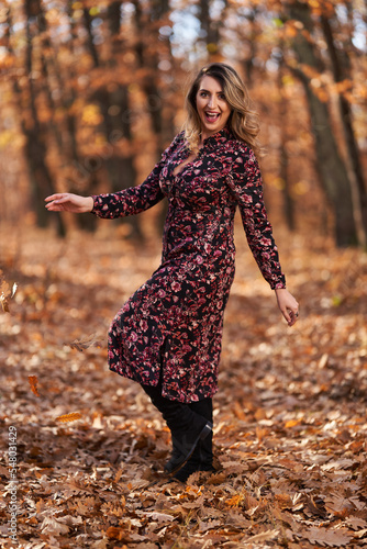 Size plus woman in a forest in the autumn