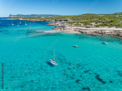 Fotobehang Expensive Motor Yacht Moored in a Peaceful Turquoise Bay