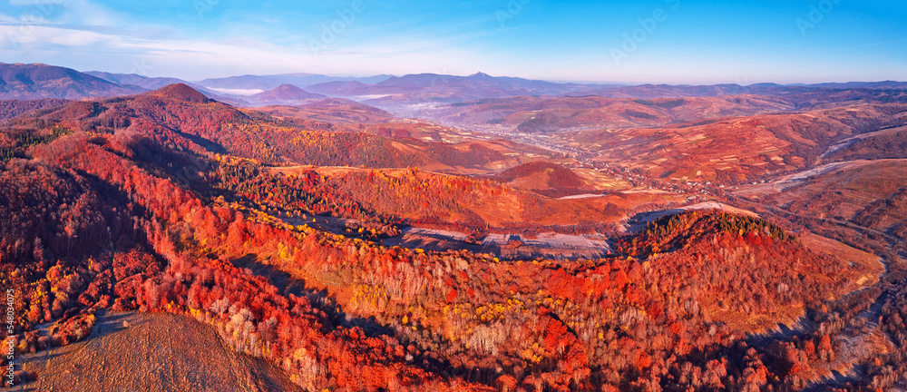 November mountain panorama. Mountain autumn misty Sunrise landscape. Morning valley covered by fog aerial scene. Seasonal fall scenery of Carpathian range