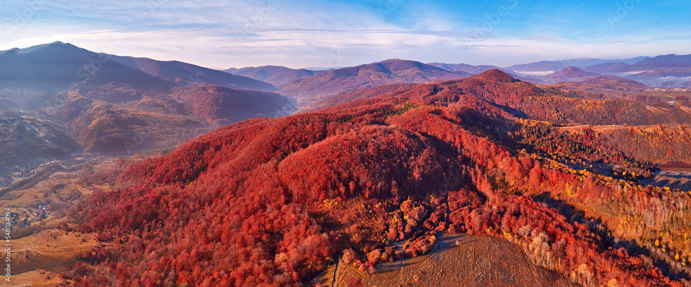 November mountain panorama. Mountain autumn misty Sunrise landscape. Morning valley covered by fog aerial scene. Seasonal fall scenery of Carpathian range