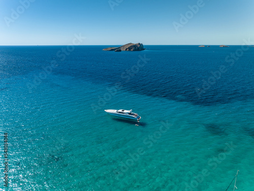 Fototapeta Naklejka Na Ścianę i Meble -  Luxury Motor Boat Anchored in Shallow Turquoise Waters
