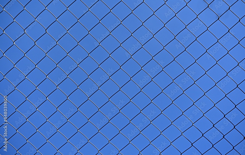 blue sky through a metal lattice. background. ecology concept blue sky through a metal lattice. background. ecology concept