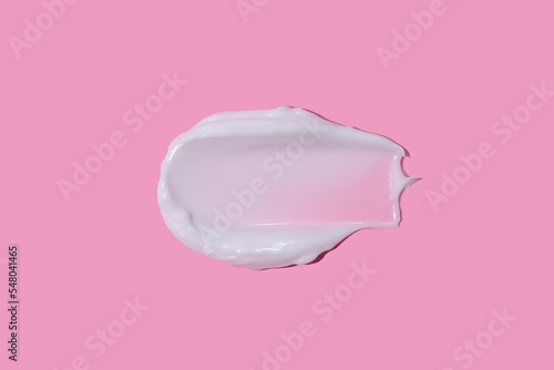 White cream smudge swatch textured on pink background
