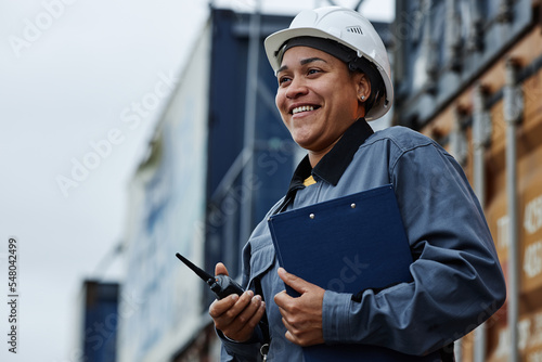 Quadro em tela Waist up portrait of young black woman wearing hardhat and smiling while working