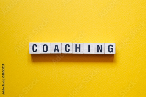 Coaching - word concept on cubes