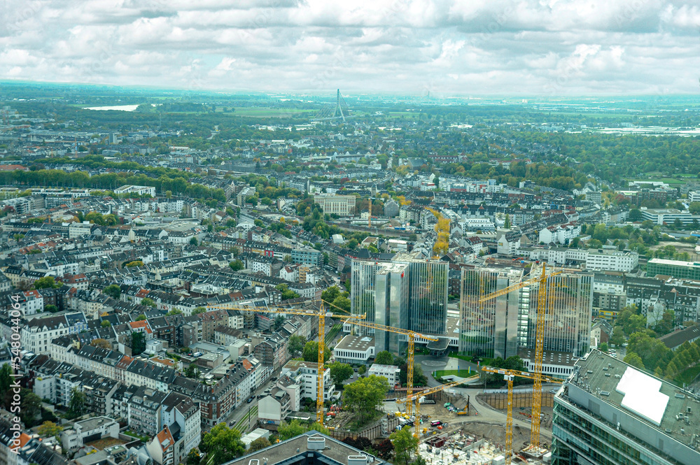 A panoramic view of the city of Dusseldorf with new construction, homes, apartments, condos, and other buildings as far as the eye can see. 