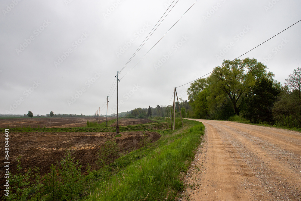 winding country road, electric transmission lines along the road