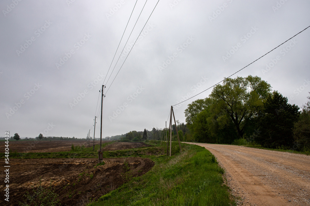 winding country road, electric transmission lines along the road