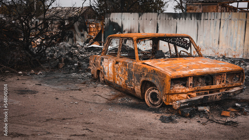 War in Ukraine, destroyed civilian car, burned car, side view. Kharkiv region
