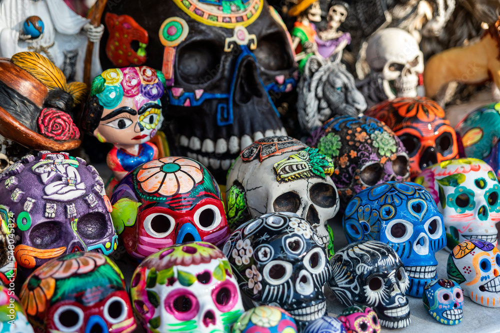 Mexican handicraft: colorful painted clay skull. A clay skull is a skull or skeleton figure commonly used for decoration during the Day of the Dead and is a typical decoration of the Mexican culture.