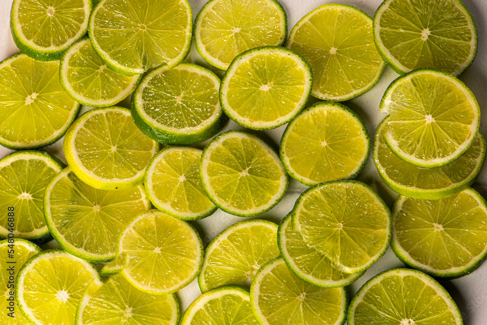 Several lemons cut into slices on white background
