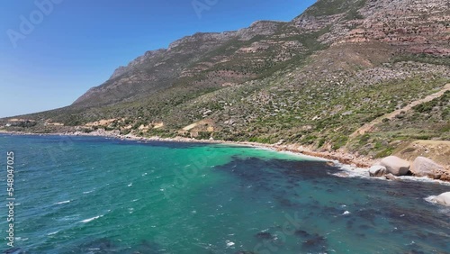 Aerial view of the sea and green-covered rocky cliffs near Cape point in South Africa