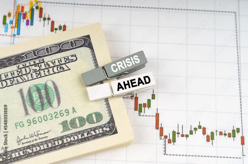 Φωτογραφία On the charts of quotations are dollars, clothespins with the inscription - CRIS