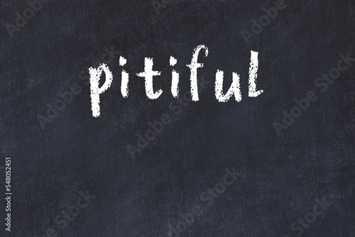 Photography College chalk desk with the word pitiful written on in