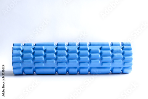 A blue foam massage roller isolated on a white background. Foam rolling is a self myofascial release technique. Gym fitness equipment. 
