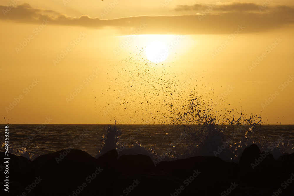 Waves splashing at rocks during sunset. Mediterranean Sea close to Agrigento,, Sicily, Italy