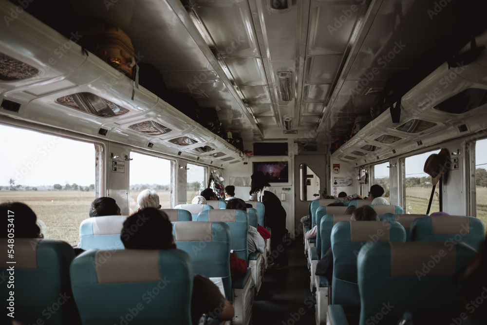 People sitting on a train in Asia People sitting on a train in Asia