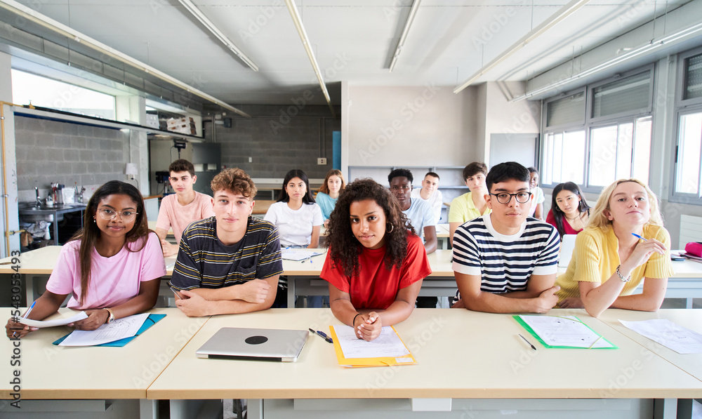 Confident group of university college sitting at classroom looking at camera with serious face. Portrait of Students of high school study together. People, education and community people. High quality Confident group of university college sitting at classroom looking at camera with serious face. Portrait of Students of high school study together. People, education and community people. High quality