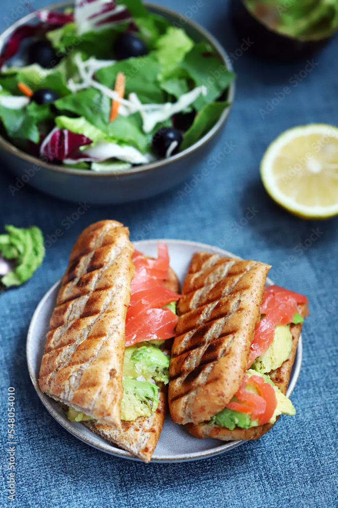 Salmon sandwich with avocado and lettuce. Salmon sandwich with avocado and lettuce.