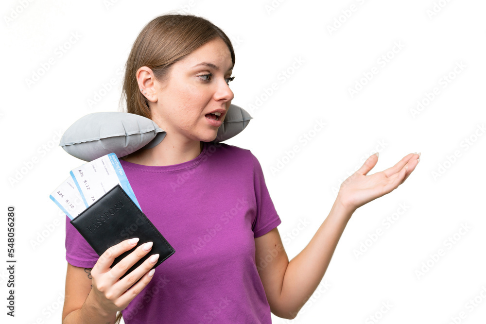 Young beautiful blonde woman with Inflatable travel Pillow over isolated background with surprise expression while looking side Young beautiful blonde woman with Inflatable travel Pillow over isolated background with surprise expression while looking side
