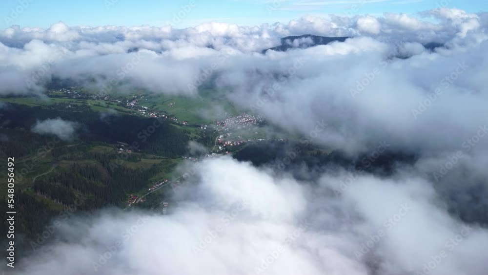Flying over low clouds in the morning. Wooded hilly country landscape. Flying over low clouds in the morning. Wooded hilly country landscape.