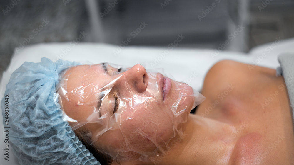 Portrait applying mask on client's face in spa salon. Wellness center. Healthcare occupation Portrait applying mask on client's face in spa salon. Wellness center. Healthcare occupation