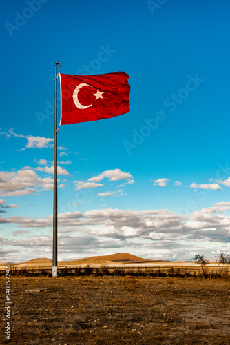 Turkish Flag waving in blue sky.